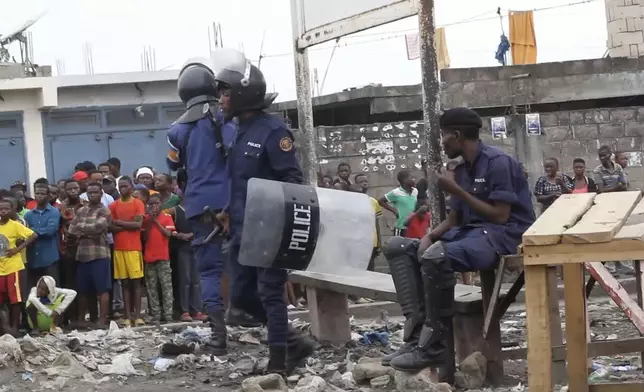 This image made from video shows police officers outside Makala prison in Kinshasa, Democratic Republic of the Congo, following an attempted jailbreak in Congo's main prison Monday Sept. 2, 2024. (AP Photo)