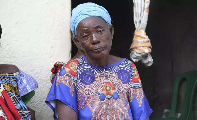 Madeleine Mbalaka, whose son was killed during the recently attempted jailbreak sits outside her house in Kinshasa, Congo, Tuesday, Sept. 3, 2024. Families of those that died in what Congo's authorities described as an attempted jailbreak in the country's biggest prison demand answers from the government, as criticism mounts over what activists describe as inhumane conditions in Congo's overcrowded penitentiary facilities. (AP Photo/Benz Bokote)