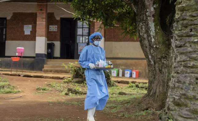 A health worker carries medication to be giving to a man suffering for mpox at the Kamituga General Hospital in South Kivu Congo, Wednesday, Sept. 4, 2024. (AP Photo/Moses Sawasawa)