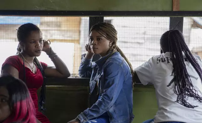 Sex workers listen to a briefing on mpox on Sept. 4, 2024, in a bar in Kamituga, in eastern Congo's South Kivu province, which is the epicenter of the world's latest outbreak of the disease. (AP Photo/Moses Sawasawa)