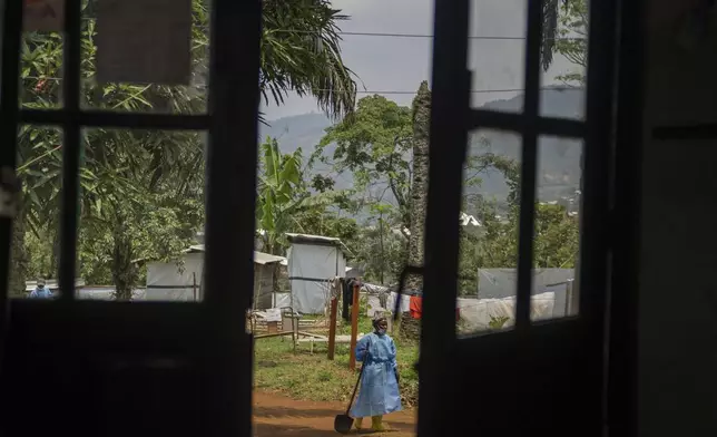 A worker carries a shovel at the hospital in Kamituga, in South Kivu province in eastern Congo on Sept. 4, 2024. South Kivu is considered the epicenter of the world's latest outbreak of mpox. (AP Photo/Moses Sawasawa)