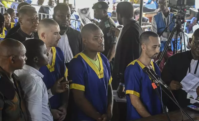 FILE - From left T,yler Thompson Jr, Marcel Malanga and Benjamin Reuben Zalman-Polun, all American citizens, face the court in Kinshasa with 52 other defendants on June 7, 2024, accused of a role in last month's attempted coup in Congo led by little-known opposition figure Christian Malanga in which six people were killed. (AP Photo/Samy Ntumba Shambuyi)