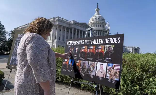 Paula Knauss touches the photo of her son Staff Sgt. Ryan C. Knauss, of Corryton, Tenn., who died during the U.S. withdrawal in Afghanistan, before a news conference at the Capitol in Washington, Monday, Sept. 9, 2024. The House Foreign Affairs Committee has released a scathing report on their investigation into the U.S. withdrawal from Afghanistan. (AP Photo/J. Scott Applewhite)