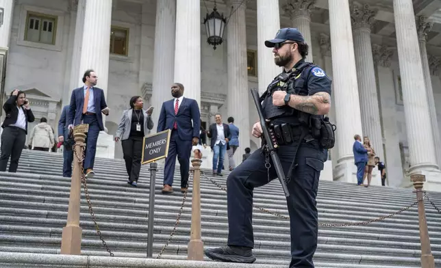 A U.S. Capitol Police officer stands watch as lawmakers leave the House of Representatives after voting on an interim spending bill to avoid a government shutdown next week, at the Capitol in Washington, Wednesday, Sept. 25, 2024. (AP Photo/J. Scott Applewhite)