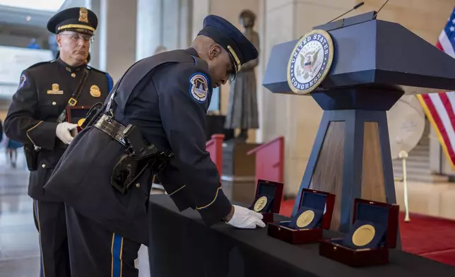 U.S. Capitol Police honor guards place Congressional Gold Medals to be presented at a ceremony to honor the Black women mathematicians of NASA who contributed to the space race and who were the subject of the movie "Hidden Figures," at the Capitol in Washington, Wednesday, Sept. 18, 2024. (AP Photo/J. Scott Applewhite)