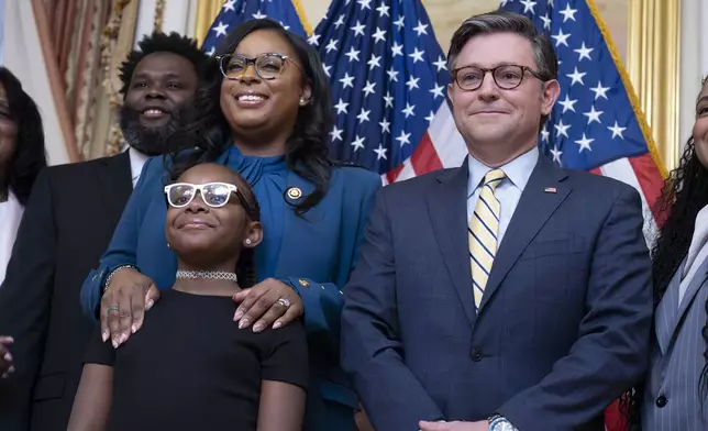 Speaker of the House Mike Johnson, R-La., right, stands with Rep. LaMonica McIver, D-N.J., left, her daughter, Zaya Thomas, and family members after her swearing-in at the Capitol in Washington, Monday, Sept. 23, 2024. McIver won a special election to finish the term of Rep. Donald Payne Jr., who died in office in April. (AP Photo/J. Scott Applewhite)