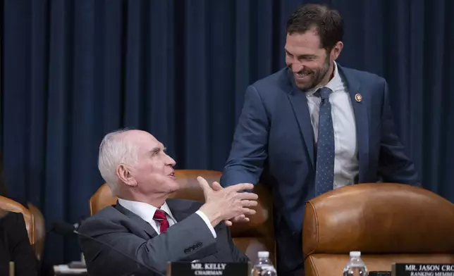 Chairman Rep. Mike Kelly, R-Pa., left, greets Ranking Member Rep. Jason Crow, D-Colo., right, at the first public hearing of a bipartisan congressional task force investigating the assassination attempts against Republican presidential nominee former President Donald Trump, at Capitol Hill in Washington, Thursday, Sept. 26, 2024. (AP Photo/Ben Curtis)