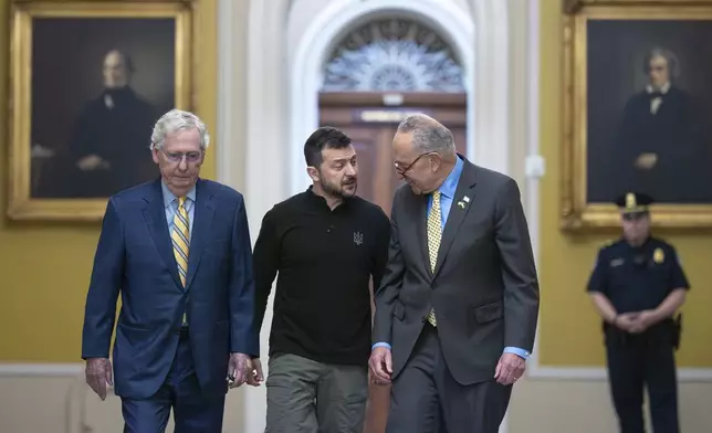 Ukrainian President Volodymyr Zelenskyy, center, walks with Senate Minority Leader Mitch McConnell, R-Ky., left, and Senate Majority Leader Chuck Schumer, D-N.Y., as he arrives for a briefing with lawmakers about the war effort against Russia, at the Capitol in Washington, Thursday, Sept. 26, 2024. (AP Photo/J. Scott Applewhite)