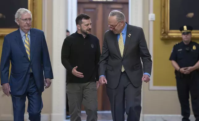 Ukrainian President Volodymyr Zelenskyy, center, walks with Senate Minority Leader Mitch McConnell, R-Ky., left, and Senate Majority Leader Chuck Schumer, D-N.Y., as he arrives for a briefing with lawmakers about the war effort against Russia, at the Capitol in Washington, Thursday, Sept. 26, 2024. (AP Photo/J. Scott Applewhite)