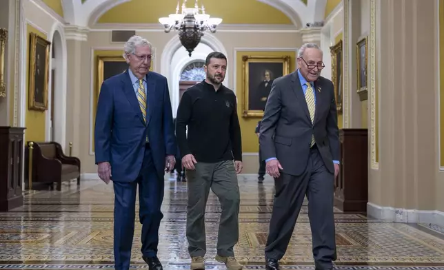 Ukrainian President Volodymyr Zelenskyy, center, walks with Senate Minority Leader Mitch McConnell, R-Ky., left, and Senate Majority Leader Chuck Schumer, D-N.Y., as he arrives for a briefing with lawmakers about the war effort against Russia, at the Capitol in Washington, Thursday, Sept. 26, 2024. (AP Photo/J. Scott Applewhite)