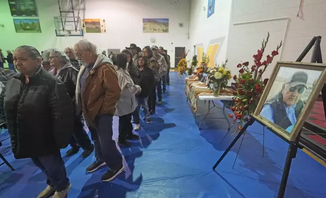 Tribal members gather in a gymnasium to pay their respects to Marvin Cota, who died from cancer, during a memorial service in Owyhee, Nev., on March 14, 2024, on the Duck Valley Indian Reservation that straddles the Nevada-Idaho border. (AP Photo/Rick Bowmer)