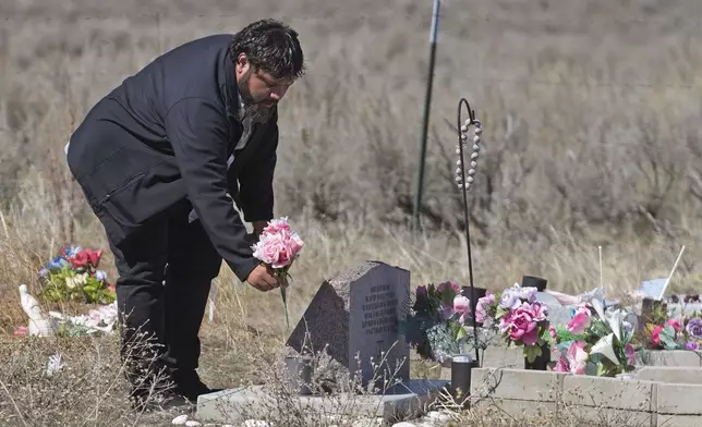 Shoshone-Paiute tribal member Michael Hanchor visits his mother’s grave, March 15, 2024, in Owyhee, Nev., on the Duck Valley Indian Reservation that straddles the Nevada-Idaho border. (AP Photo/Rick Bowmer)