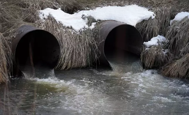 Water flows through a culvert at an irrigation canal on the Duck Valley Indian Reservation, March 13, 2024, in Owyhee, Nev. (AP Photo/Rick Bowmer)