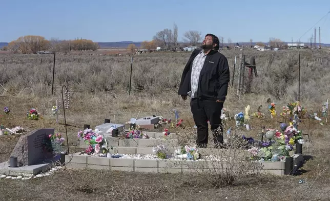 Shoshone-Paiute tribal member Michael Hanchor visits his mother’s grave, March 15, 2024, in Owyhee, Nev., on the Duck Valley Indian Reservation that straddles the Nevada-Idaho border. (AP Photo/Rick Bowmer)