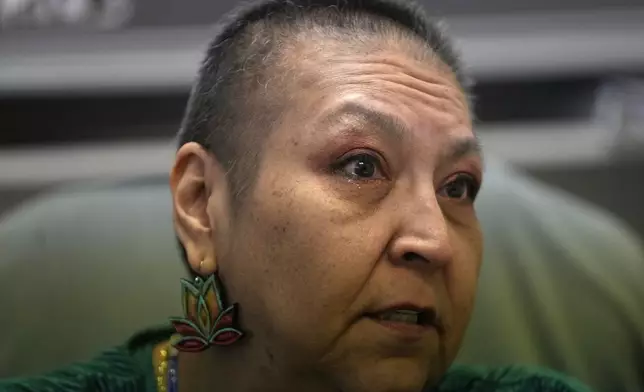 Julie Manning, who is currently battling cancer, speaks at the tribal health clinic where she works as an accounting specialist on March 15, 2024, in Owyhee, Nev., on the Duck Valley Indian Reservation that straddles the Nevada-Idaho border. (AP Photo/Rick Bowmer)