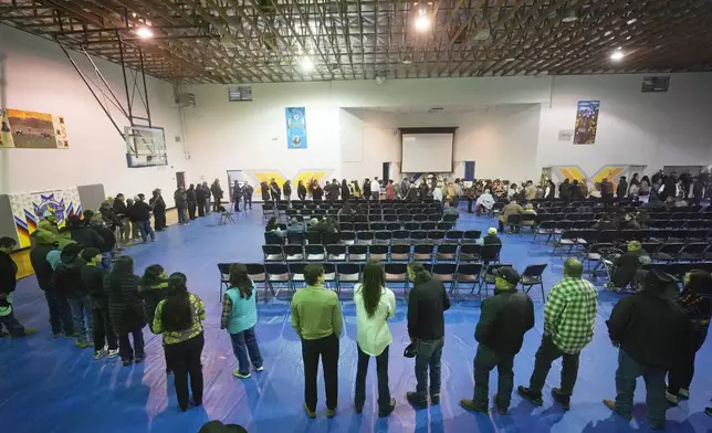 Tribal members gather in a gymnasium to pay their respects to Marvin Cota, who died from cancer, during a memorial service in Owyhee, Nev., on March 14, 2024, on the Duck Valley Indian Reservation that straddles the Nevada-Idaho border. (AP Photo/Rick Bowmer)