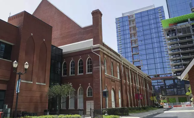 FILE - The Ryman Auditorium is surrounded by newer buildings in Nashville, Tenn., on April 16, 2020. (AP Photo/Mark Humphrey)