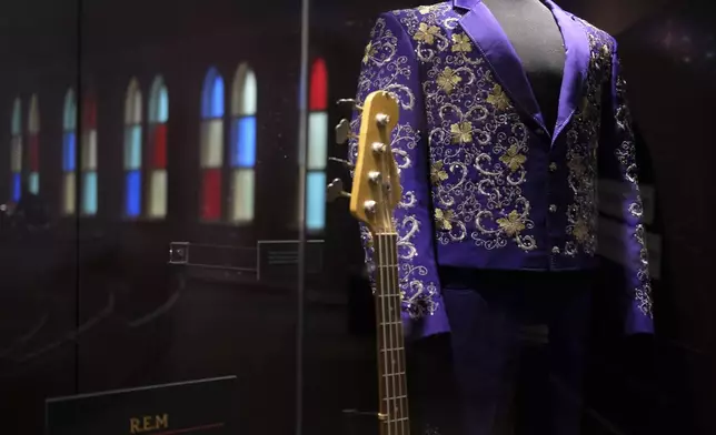 Instruments and clothing worn by artists are displayed at the Ryman Auditorium in Nashville, Tenn., on July 30, 2024. (AP Photo/Luis Andres Henao)