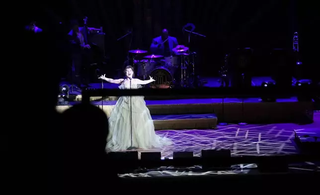 Members of the band Postmodern Jukebox perform on stage at the Ryman Auditorium during a concert in Nashville, Tenn., on July 30, 2024. (AP Photo/Luis Andres Henao)