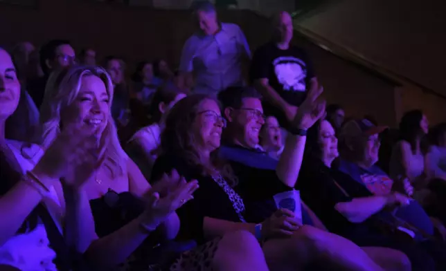 The audience reacts during a performance at the Ryman Auditorium in Nashville, Tenn., on July 30, 2024. (AP Photo/Luis Andres Henao)