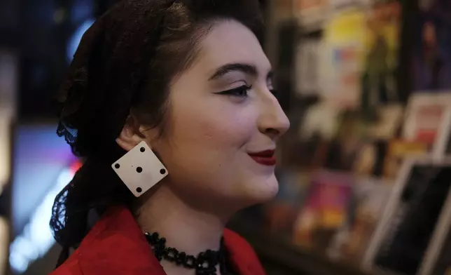 Greer Elise Barajas stands for a portrait at the Ryman Auditorium gift shop before attending a concert by the band Postmodern Jukebox in Nashville, Tenn., on July 30, 2024. (AP Photo/Luis Andres Henao)