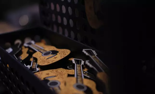 Guitar magnets are displayed at the Ryman Auditorium gift shop in Nashville, Tenn., on July 30, 2024. (AP Photo/Luis Andres Henao)