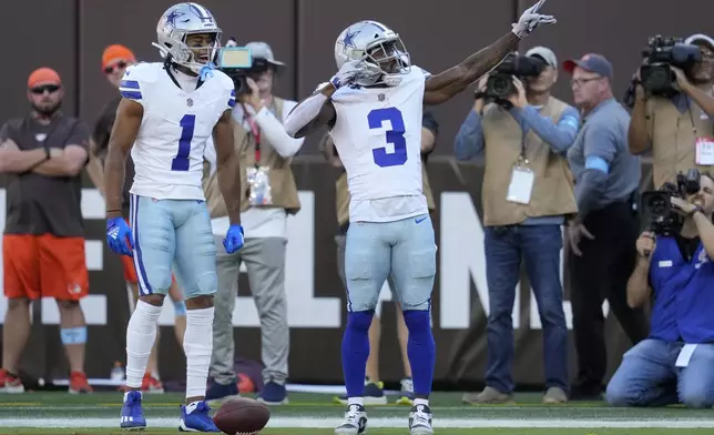 Dallas Cowboys wide receiver Brandin Cooks (3) and Jalen Tolbert (1) celebrate Cook's touchdown catch against the Cleveland Browns in the first half of an NFL football game in Cleveland, Sunday, Sept. 8, 2024. (AP Photo/Sue Ogrocki)