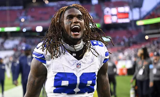 Dallas Cowboys' CeeDee Lamb celebrates as he walks off the field after an NFL football game against the Cleveland Browns in Cleveland, Sunday, Sept. 8, 2024. (AP Photo/David Richard)