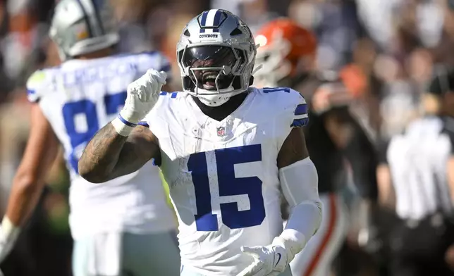 Dallas Cowboys running back Ezekiel Elliott celebrates after rushing for a touchdown against the Cleveland Browns in the first half of an NFL football game in Cleveland, Sunday, Sept. 8, 2024. (AP Photo/David Richard)