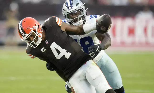 Cleveland Browns quarterback Deshaun Watson (4) runs for a gain before being tackled by Dallas Cowboys linebacker Damone Clark (18) in the second half of an NFL football game in Cleveland, Sunday, Sept. 8, 2024. (AP Photo/Sue Ogrocki)