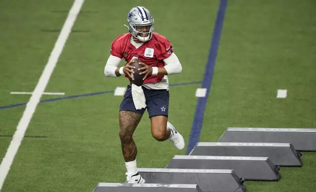 Dallas Cowboys quarterback Dak Prescott (4) runs drills during an NFL football practice at the team's training facility, Wednesday, Aug. 28, 2024, in Frisco, Texas. (AP Photo/Tony Gutierrez)