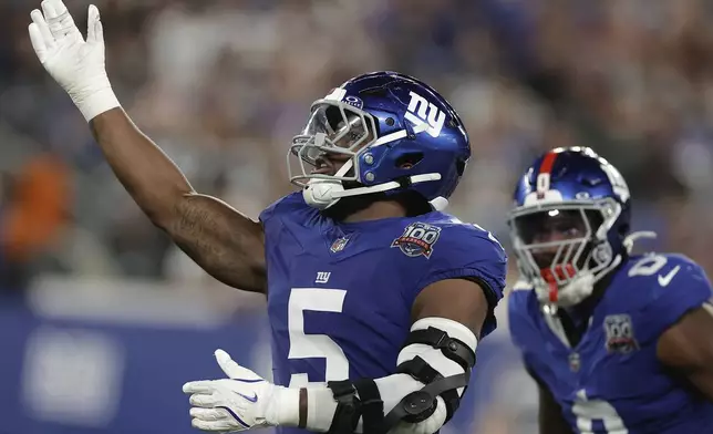 New York Giants linebacker Kayvon Thibodeaux (5) reacts after sacking Dallas Cowboys quarterback Dak Prescott (4) during the second quarter of an NFL football game, Thursday, Sept. 26, 2024, in East Rutherford, N.J. (AP Photo/Adam Hunger)