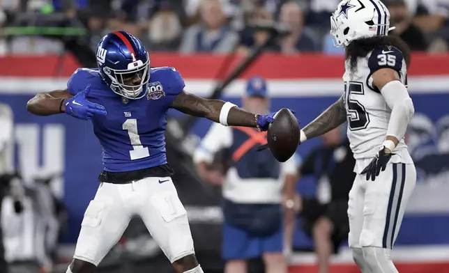 New York Giants wide receiver Malik Nabers (1) reacts after a first down against the Dallas Cowboys during the third quarter of an NFL football game, Thursday, Sept. 26, 2024, in East Rutherford, N.J. (AP Photo/Adam Hunger)