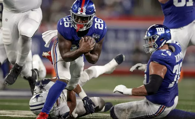 New York Giants running back Devin Singletary (26) carries the ball against the Dallas Cowboys during the second quarter of an NFL football game, Thursday, Sept. 26, 2024, in East Rutherford, N.J. (AP Photo/Adam Hunger)