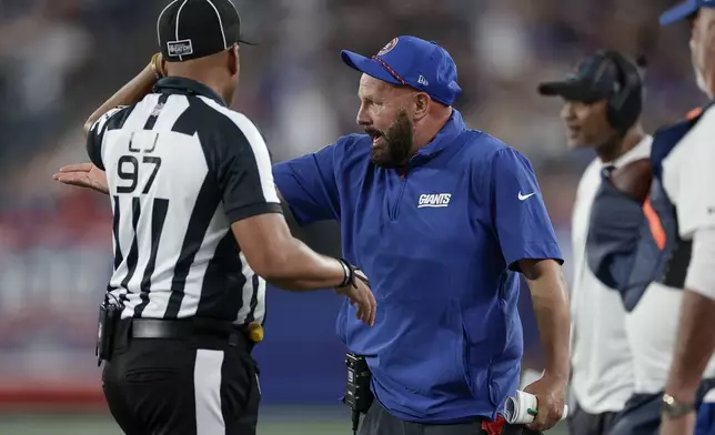 New York Giants head coach Brian Daboll comments to field judge Tom Hill (97) during the first quarter of an NFL football game against the Dallas Cowboys, Thursday, Sept. 26, 2024, in East Rutherford, N.J. (AP Photo/Adam Hunger)