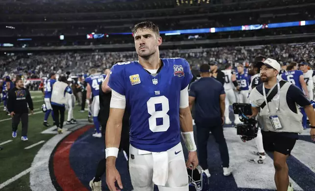 New York Giants quarterback Daniel Jones (8) walks off the field after playing against the Dallas Cowboys in an NFL football game, Thursday, Sept. 26, 2024, in East Rutherford, N.J. (AP Photo/Adam Hunger)