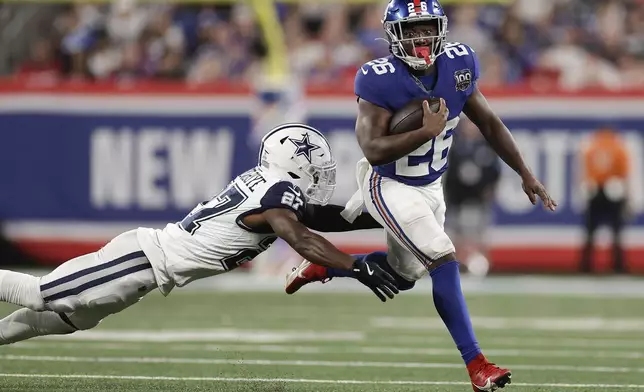 New York Giants running back Devin Singletary (26) carries the ball against =c27= during the fourth quarter of an NFL football game, Thursday, Sept. 26, 2024, in East Rutherford, N.J. (AP Photo/Adam Hunger)