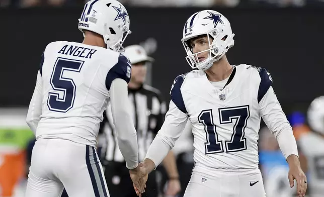 Dallas Cowboys place kicker Brandon Aubrey (17) is congratulated by punter Bryan Anger (5) after kicking a 40-yard field goal against the New York Giants during the fourth quarter of an NFL football game, Thursday, Sept. 26, 2024, in East Rutherford, N.J. (AP Photo/Adam Hunger)