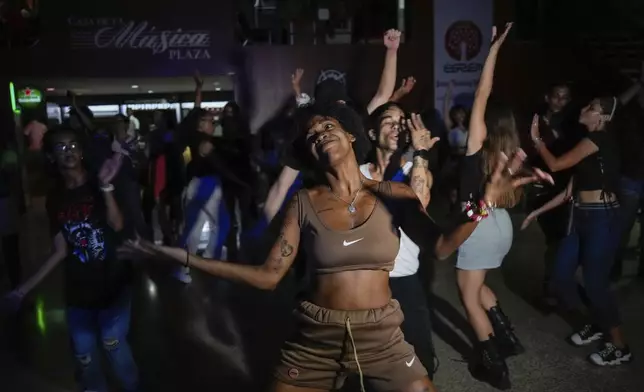 Karla Piña Costa dances with other youths to K-pop, popular Korean music, at a cultural house in Havana, Cuba, Saturday, Sept. 7, 2024. (AP Photo/Ramon Espinosa)