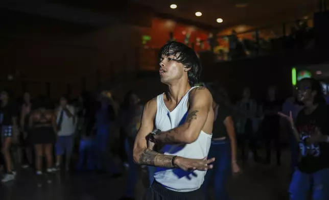 Dancer Francisco Piedra, known by stagename "Ken," dances to a K-pop, or popular Korean music, at a cultural house in Havana, Cuba, Saturday, Sept. 7, 2024. (AP Photo/Ramon Espinosa)