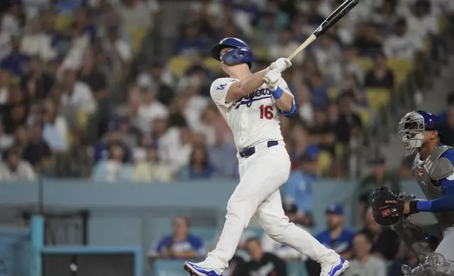 Los Angeles Dodgers' Will Smith hits a home run during the first inning of a baseball game against the Chicago Cubs in Los Angeles, Wednesday, Sept. 11, 2024. (AP Photo/Ashley Landis)