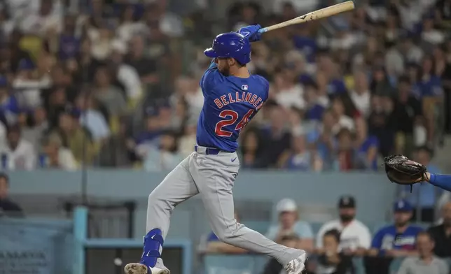 Chicago Cubs' Cody Bellinger (24) hits a home run during the fifth inning of a baseball game against the Los Angeles Dodgers in Los Angeles, Wednesday, Sept. 11, 2024. Ian Happ and Dansby Swanson also scored. (AP Photo/Ashley Landis)