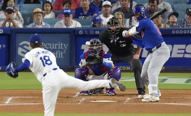 Los Angeles Dodgers starting pitcher Yoshinobu Yamamoto, left, pitches to Chicago Cubs' Seiya Suzuki, right, as catcher Austin Barnes, second from left, and home plate umpire Cory Blaser watch during the first inning of a baseball game, Tuesday, Sept. 10, 2024, in Los Angeles. (AP Photo/Mark J. Terrill)