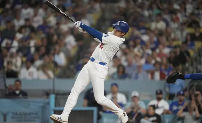 Los Angeles Dodgers designated hitter Shohei Ohtani (17) hits a home run during the first inning of a baseball game against the Chicago Cubs in Los Angeles, Wednesday, Sept. 11, 2024. (AP Photo/Ashley Landis)