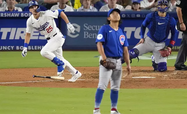 Los Angeles Dodgers' Tommy Edman, left, heads to first for a solo home run as Chicago Cubs starting pitcher Shota Imanaga, center, and catcher Miguel Amaya watch during the fourth inning of a baseball game, Tuesday, Sept. 10, 2024, in Los Angeles. (AP Photo/Mark J. Terrill)