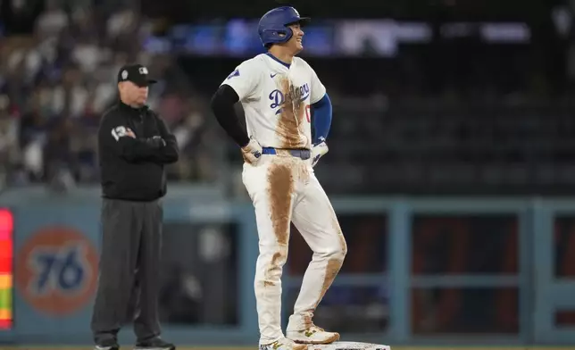 Los Angeles Dodgers designated hitter Shohei Ohtani (17) stands on second base during the third inning of a baseball game against the Chicago Cubs in Los Angeles, Wednesday, Sept. 11, 2024. (AP Photo/Ashley Landis)