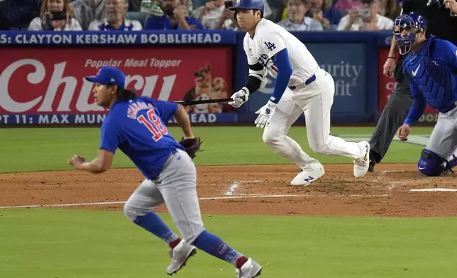 Chicago Cubs starting pitcher Shota Imanaga, left, and Los Angeles Dodgers' Shohei Ohtani, center, run to first as Ohtani grounds into a double play as catcher Miguel Amaya watches during the third inning of a baseball game, Tuesday, Sept. 10, 2024, in Los Angeles. (AP Photo/Mark J. Terrill)