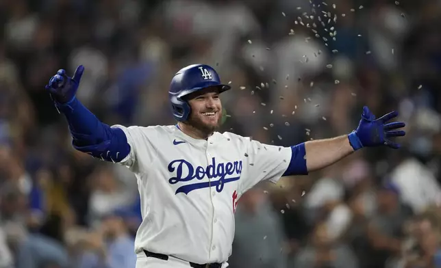 Los Angeles Dodgers' Max Muncy celebrates after hitting a home run during the first inning of a baseball game against the Chicago Cubs in Los Angeles, Wednesday, Sept. 11, 2024. (AP Photo/Ashley Landis)