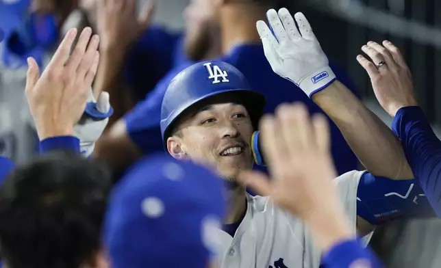 Los Angeles Dodgers' Tommy Edman celebrates after hitting a home run during the first inning of a baseball game against the Chicago Cubs in Los Angeles, Wednesday, Sept. 11, 2024. Teoscar Hernández also scored. (AP Photo/Ashley Landis)