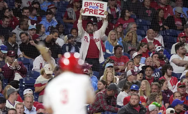 A fan cheers for Philadelphia Phillies' Bryce Harper during the eighth inning of a baseball game against the Chicago Cubs, Wednesday, Sept. 25, 2024, in Philadelphia. (AP Photo/Matt Slocum)